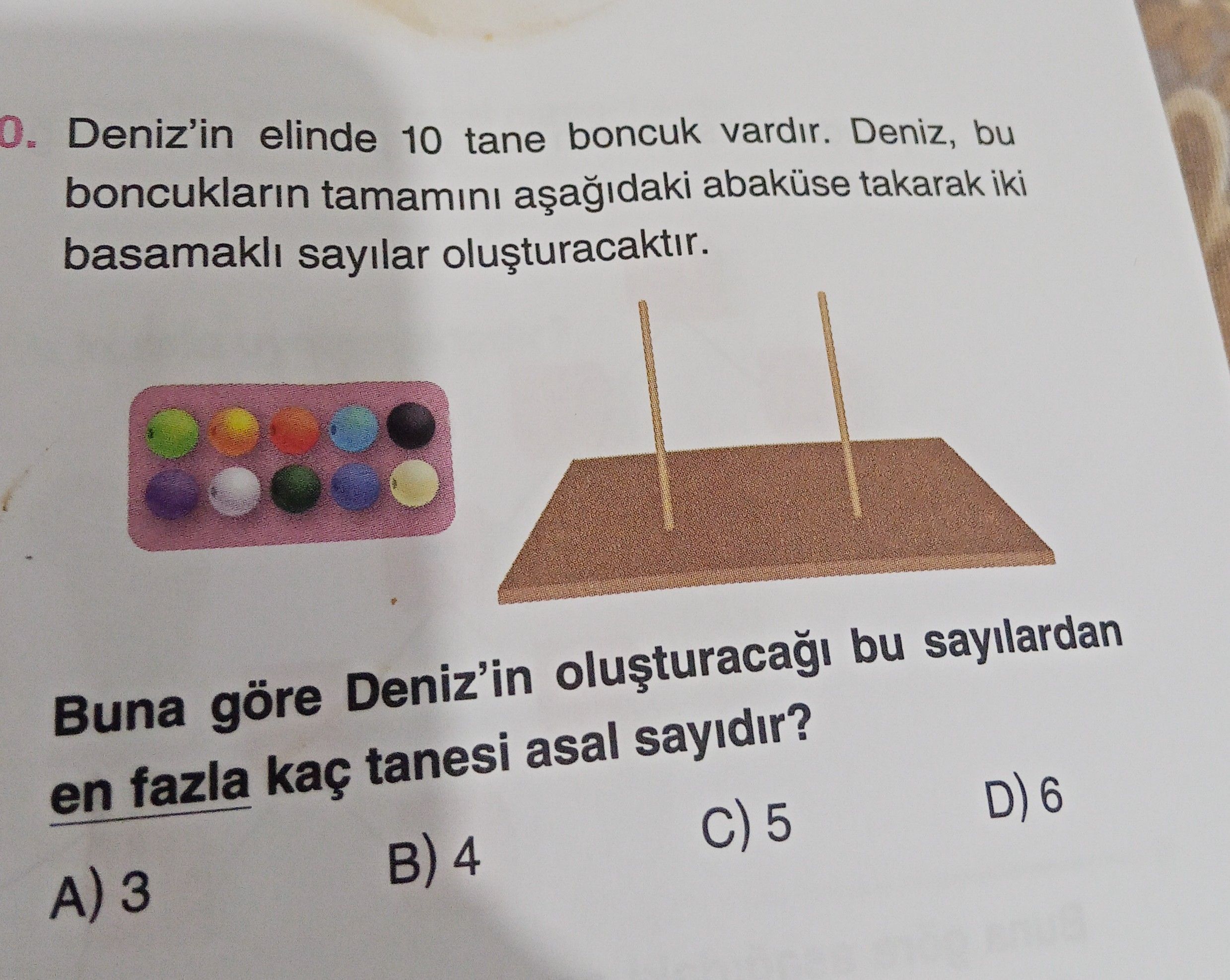 Deniz'in elinde 10 tane boncuk vardır. Deniz, bu boncukların tamamını aşağıdaki abaküse takarak iki