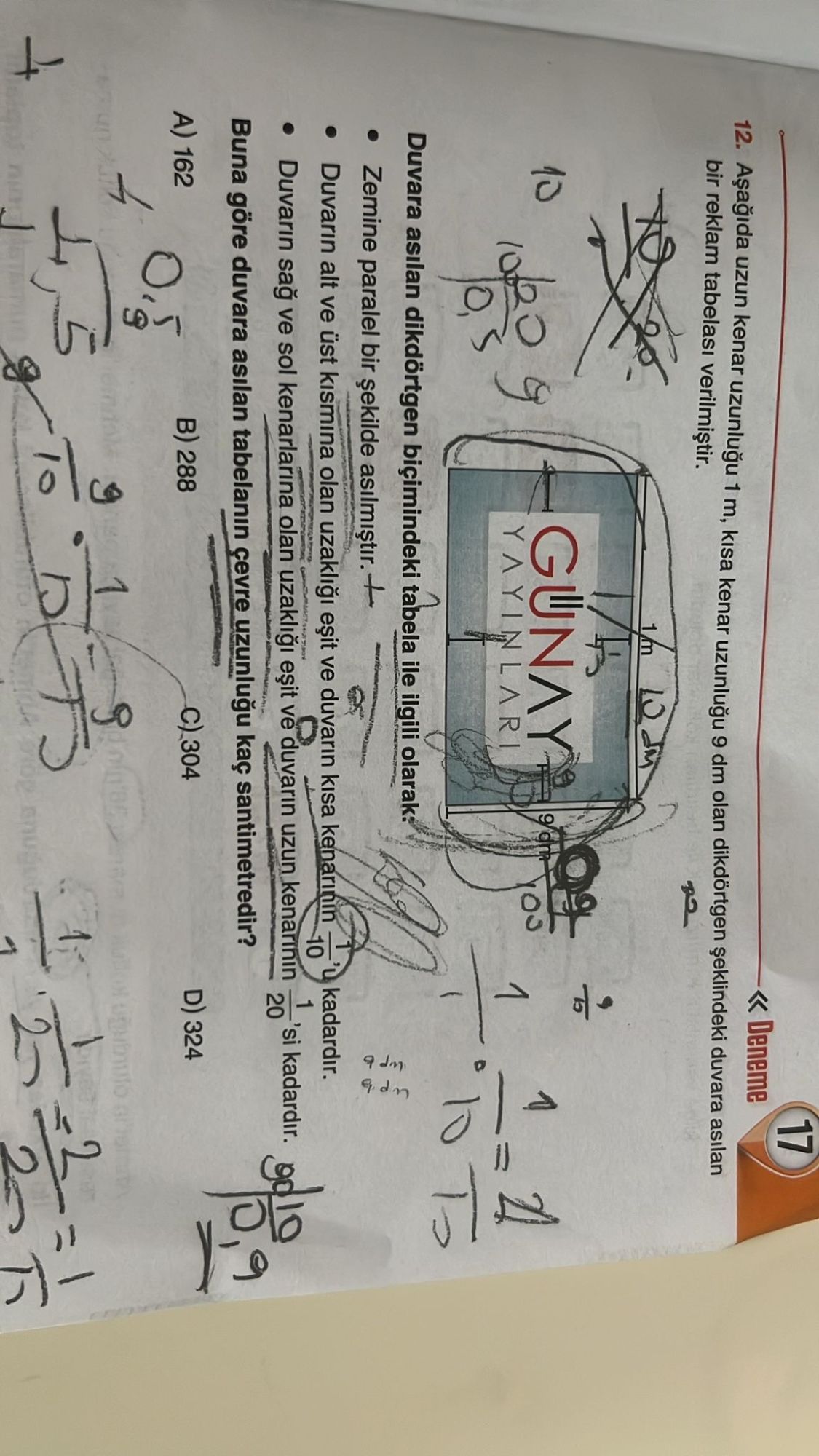 Aşağıda uzun kenar uzunluğu 1 m, kısa kenar uzunluğu 9 dm olan dikdörtgen şeklindeki duvara asılan