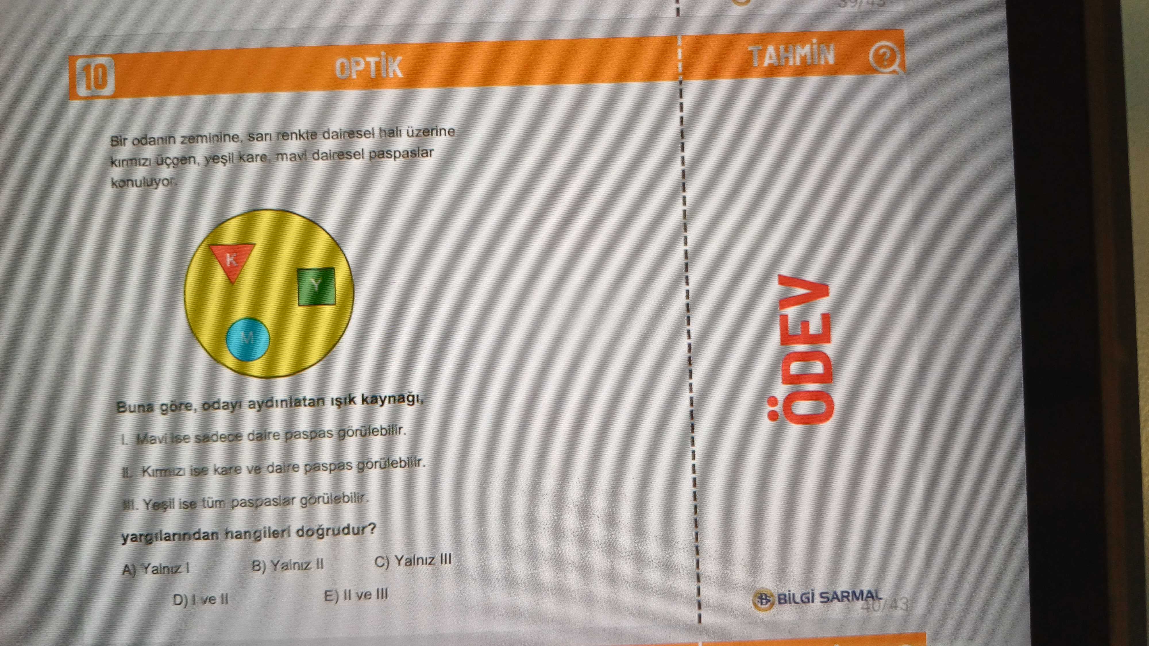 Bir odanın zeminine, sarı renkte dairesel halı üzerine kırmızı üçgen, yeşil kare, mavi dairesel